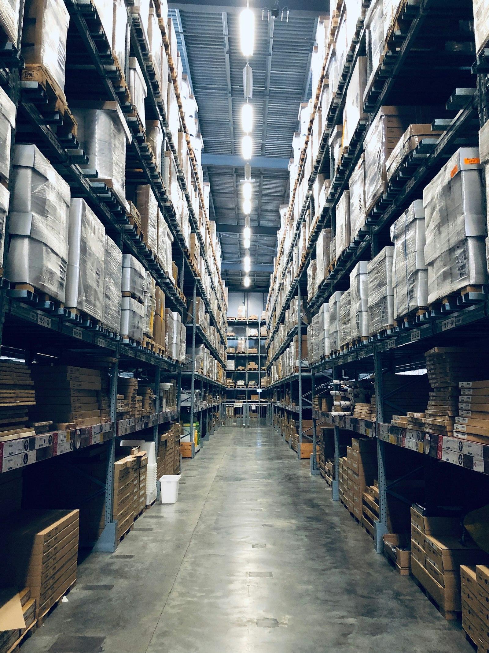 High-bay warehouse aisle stocked with palletized goods